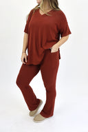 Model wearing Ribbed Flare Set by AJ in rust color. Shows side pockets.