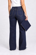 Model wearing Tummy Control Wide Leg dark wash in our 40" inseam cut to length. Showing the jeans have been cut.