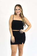 model wearing The Athletic Skort in black with white polka dots.