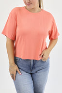 Model wearing Everyday Tee in Coral color.