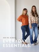 Two women standing side by side wearing casual clothing with text "XXS-4X. ALWAYS." and 'Everyday Essentials'.