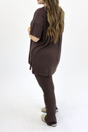 Model wearing Ribbed Flare Set by AJ in raisin color. ( back view)