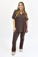 Model wearing Ribbed Flare Set by AJ in raisin color.