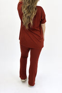 Model wearing Ribbed Flare Set by AJ in rust color. (back view)