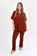 Model wearing Ribbed Flare Set by AJ in rust color.