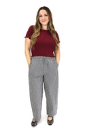 model wearing AJ Linen Barrel Pants in black gingham print.