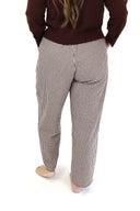 model wearing AJ Linen Barrel Pants in brown gingham print.
