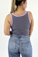 Model wearing The Striped Micro Ribbed Tank in grey base with purple stripes. Back view.