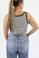 Model wearing The Striped Micro Ribbed Tank in white base with black stripes. Back view.