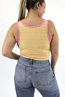 Model wearing The Striped Micro Ribbed Tank in yellow base with pink stripes. Back view.