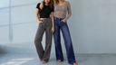 2 models wearing the NEW AJ wide leg tummy control jeans. One mid rise dark wash and one grey leopard wash.