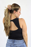 model wearing Open Back Tank in black ribbed material. 