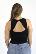 model wearing Open Back Tank in black ribbed material. Back View.