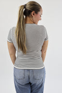 Back shot of woman in white and black striped, ribbed, full length, short sleeve, crewneck tee