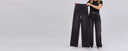 Women wearing a cut to length 40" original inseam black wide leg while holding a 40" inseam jean in her hands to show how long they are.
