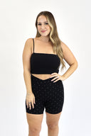 model wearing AJ Tummy Control Crossover Biker Shorts with 6" inseam and white polka dot print on black