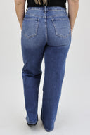 Model wearing Wide Leg Tummy Control Jeans in a medium wash with rhinestones down the side seam. (back view)