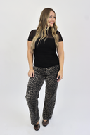 Model wearing Tummy Control Wide Leg jeans in a dark leopard print