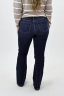 Model wearing Tummy Control Flare Jeans by RFM - dark wash
