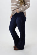 Model wearing Tummy Control Flare Jeans by RFM - dark wash